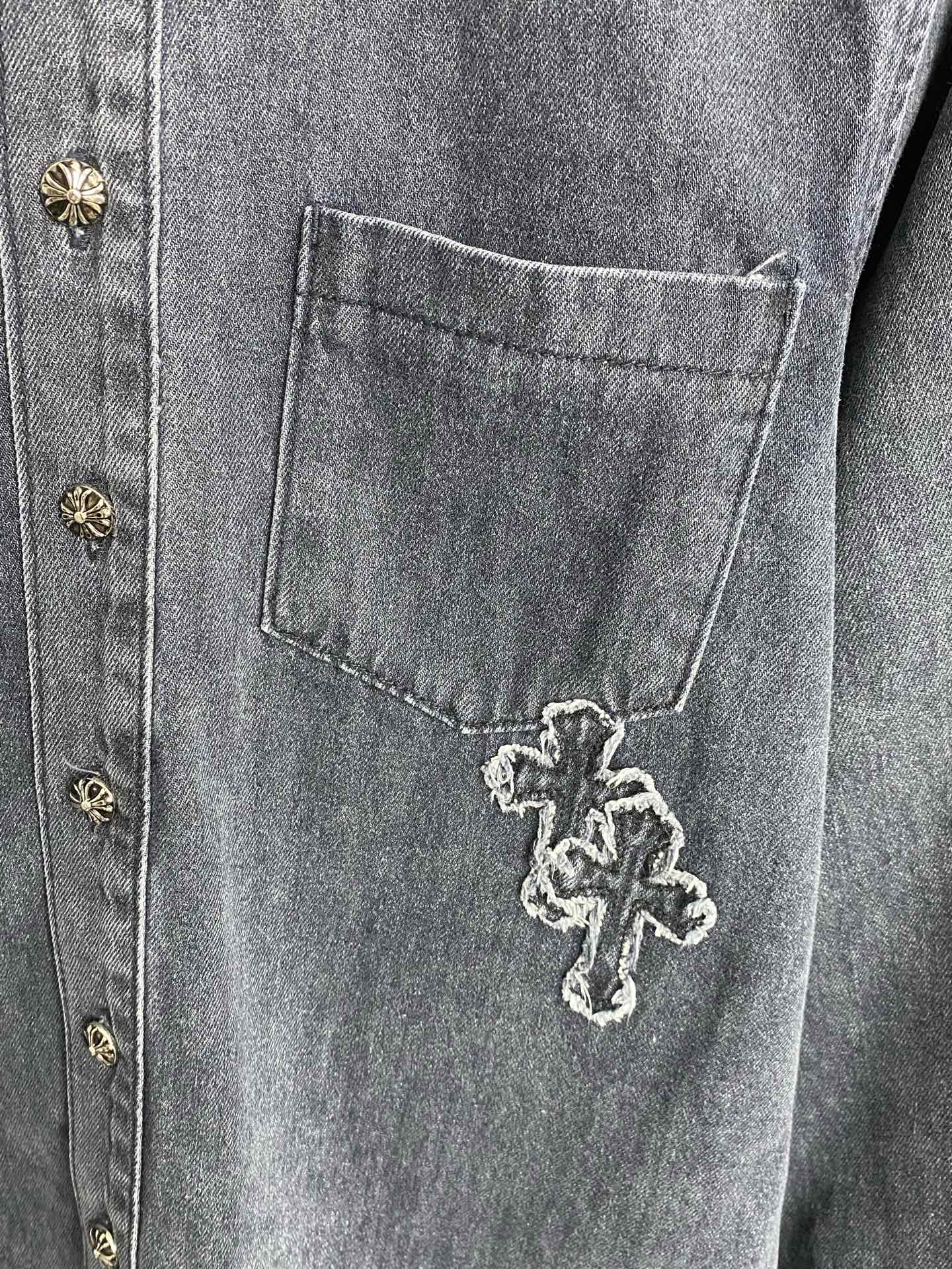Dark blue denim chest pocket with embroidered cross detail