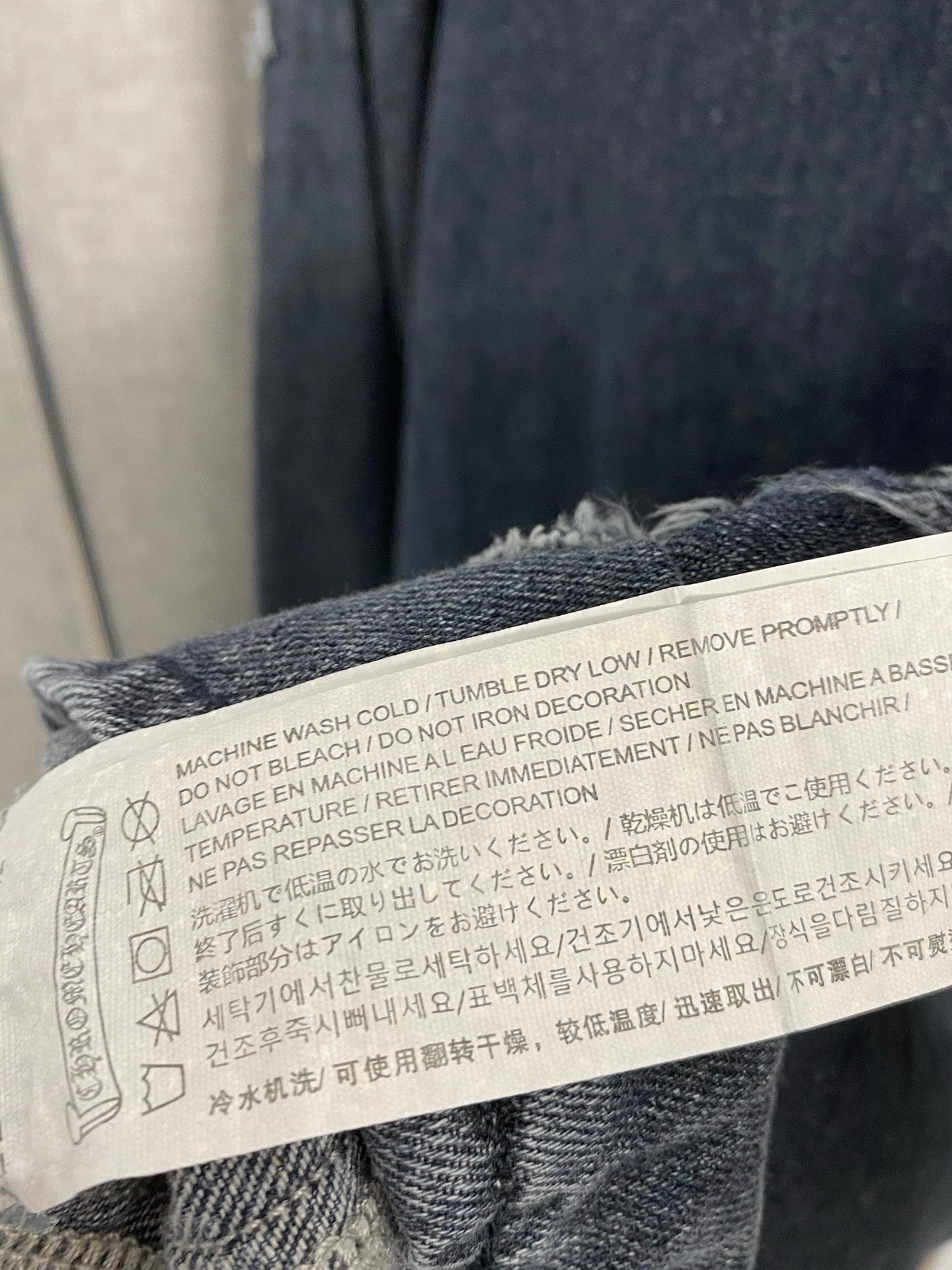 Denim jacket care label with washing and drying instructions