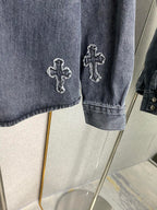 Denim jacket sleeve with embroidered cross patch and buttoned cuff