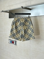Burberry plaid shorts with elastic waist and side pockets, folded at hanger.