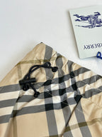 Burberry plaid shorts close-up of elastic waistband and black drawstring ties.