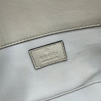 White bag interior close-up with Gucci logo label patch
