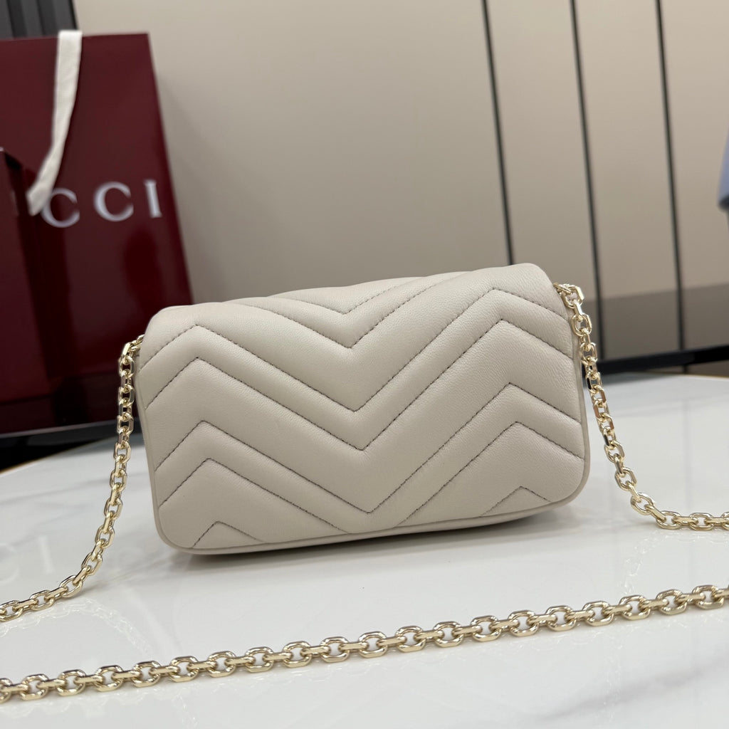 Small quilted crossbody bag with chevron pattern and gold-tone chain strap