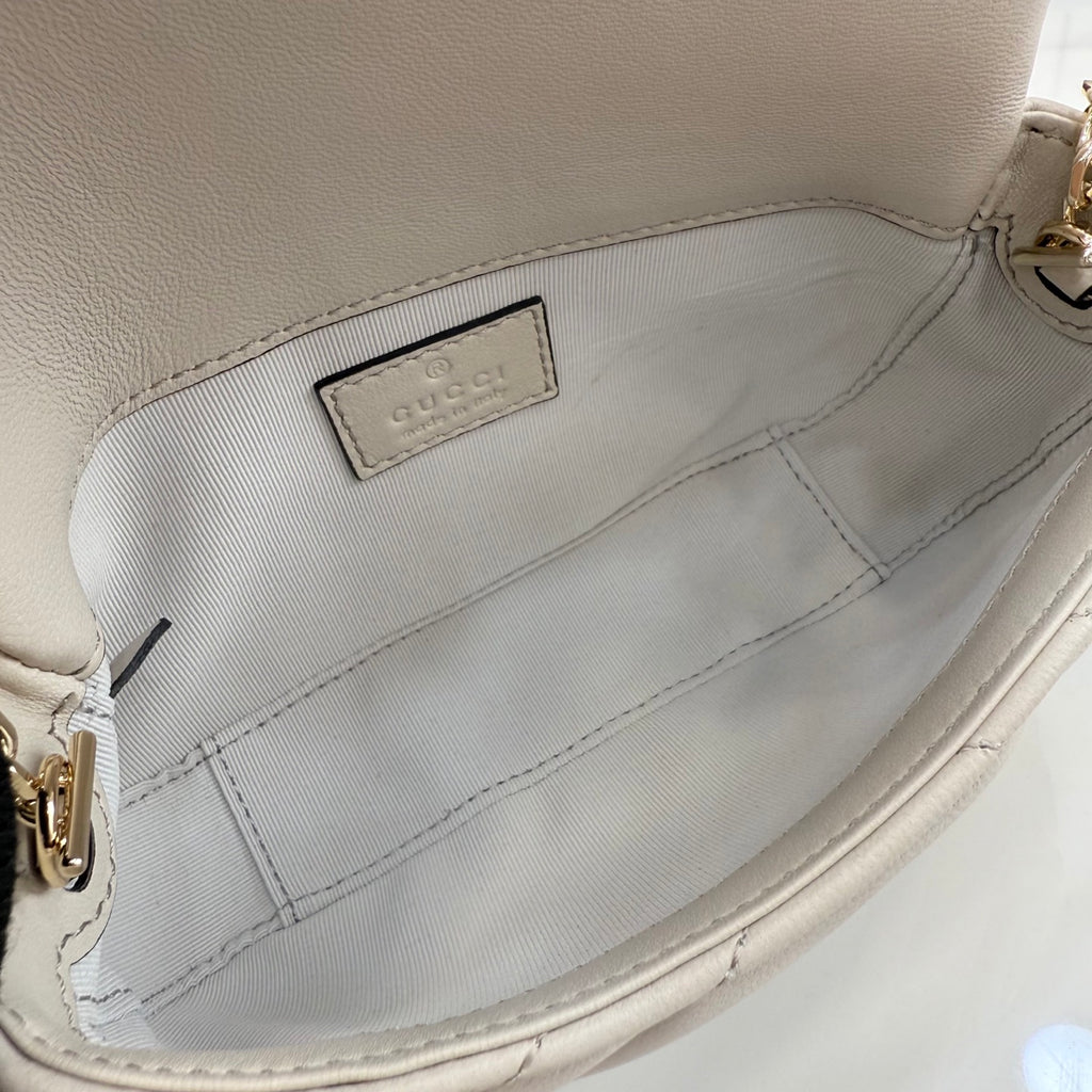 Small quilted bag interior lining with fabric logo tag and side seam stitching