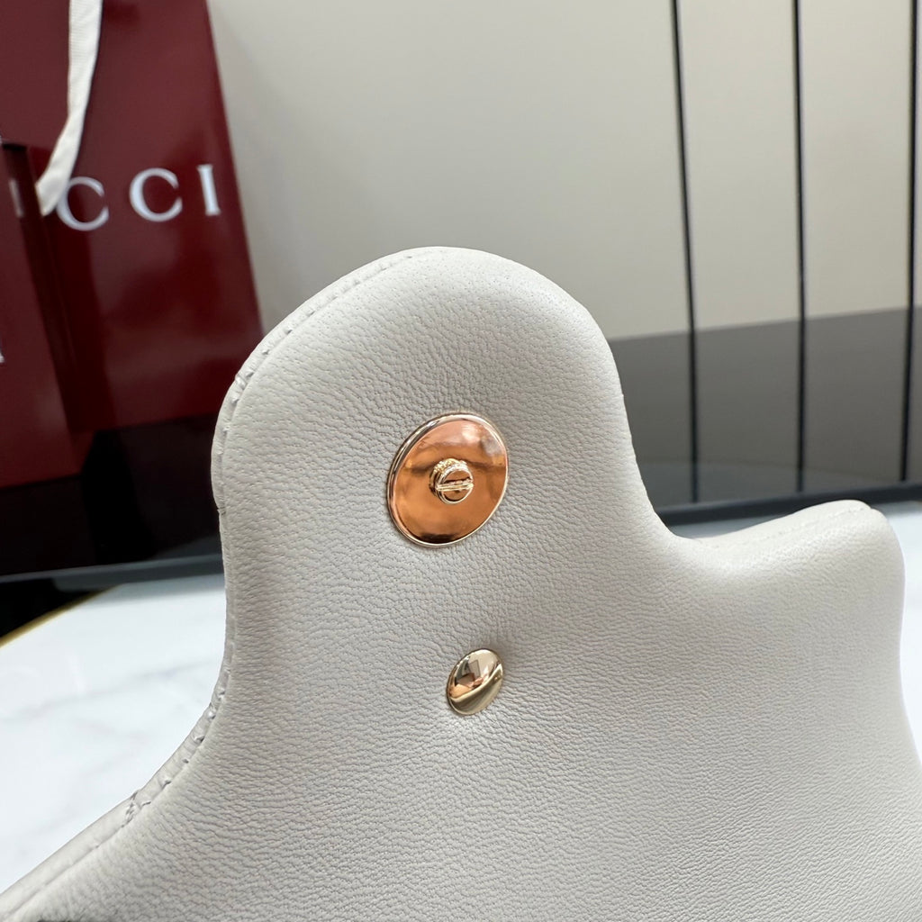 White pebbled leather shoulder bag back with gold-tone button hardware