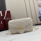 Small quilted shoulder bag in light color with chevron pattern and Gucci Double G clasp