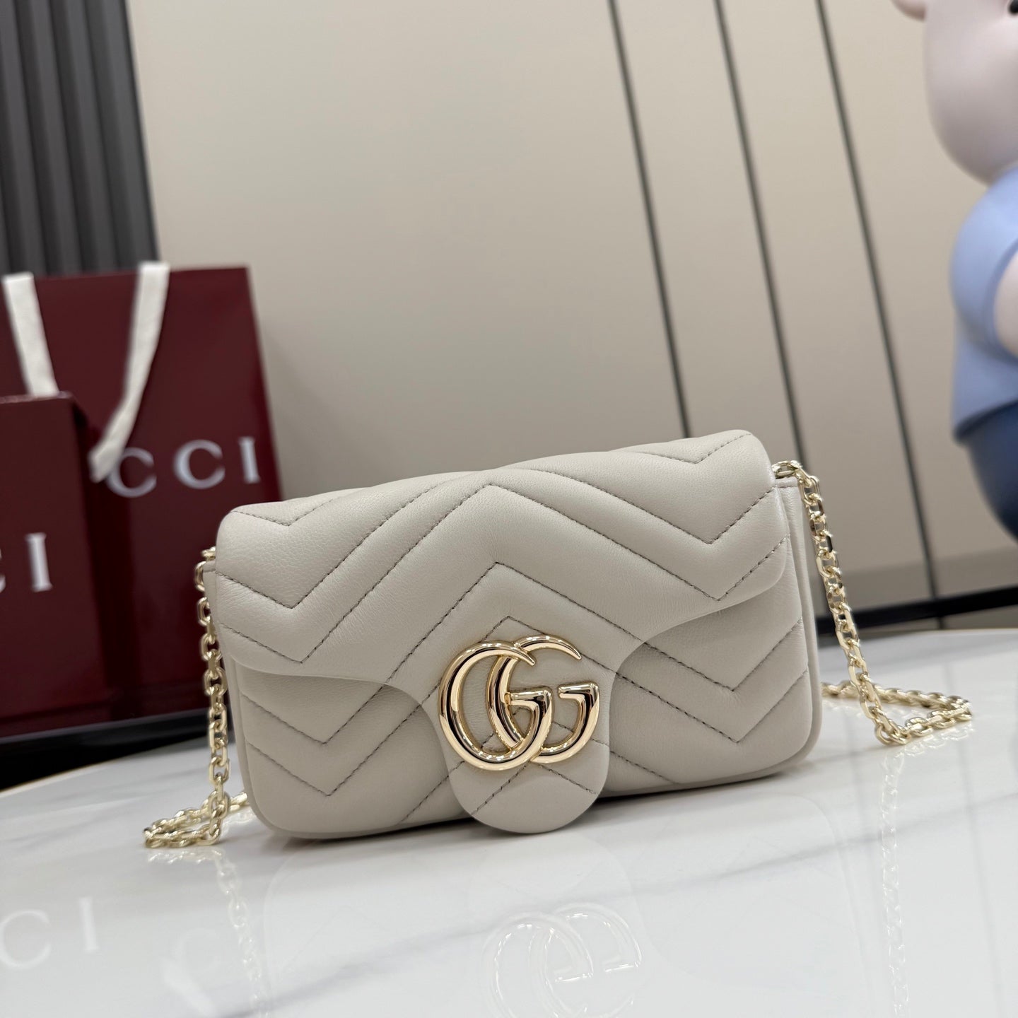 White quilted shoulder bag with chevron stitching and gold-tone chain strap