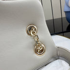 Off-white leather bag corner with gold-tone chain loop hardware and stitched trim