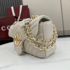 Off-white quilted leather shoulder bag with gold-tone chain and GG logo charm