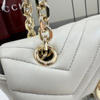 Gucci bag with light leather body, gold-tone chain strap and clasp hardware
