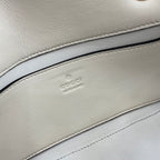 Gucci logo embossing on off-white leather lining inside the bag