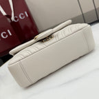 Off-white quilted leather shoulder bag back view with slim top handle and gold lock detail