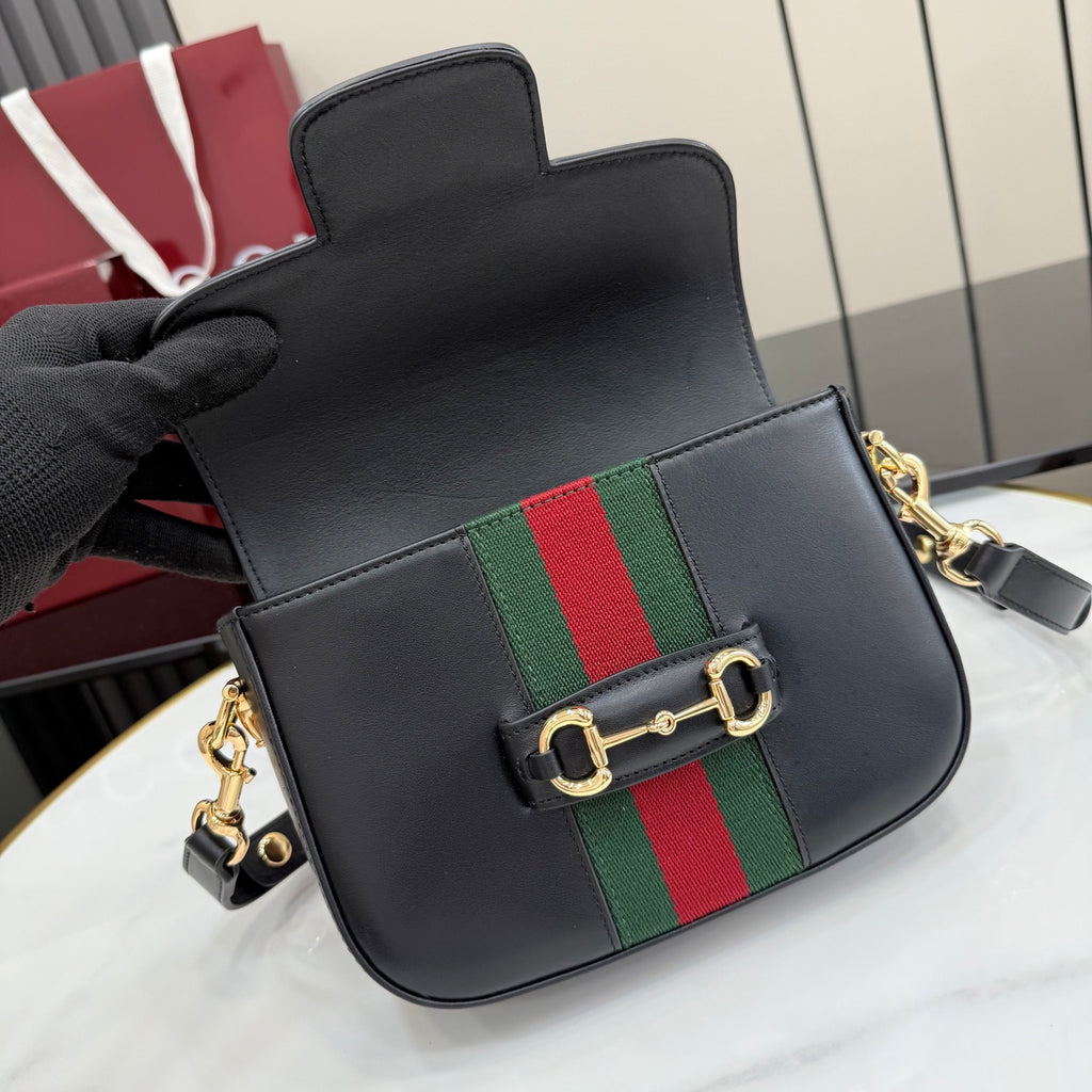 Gucci crossbody bag close front view with black leather, green and red stripe, gold clasp