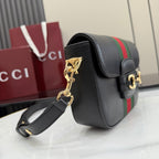 Gucci crossbody bag side view in black leather with green-red stripe and gold hardware