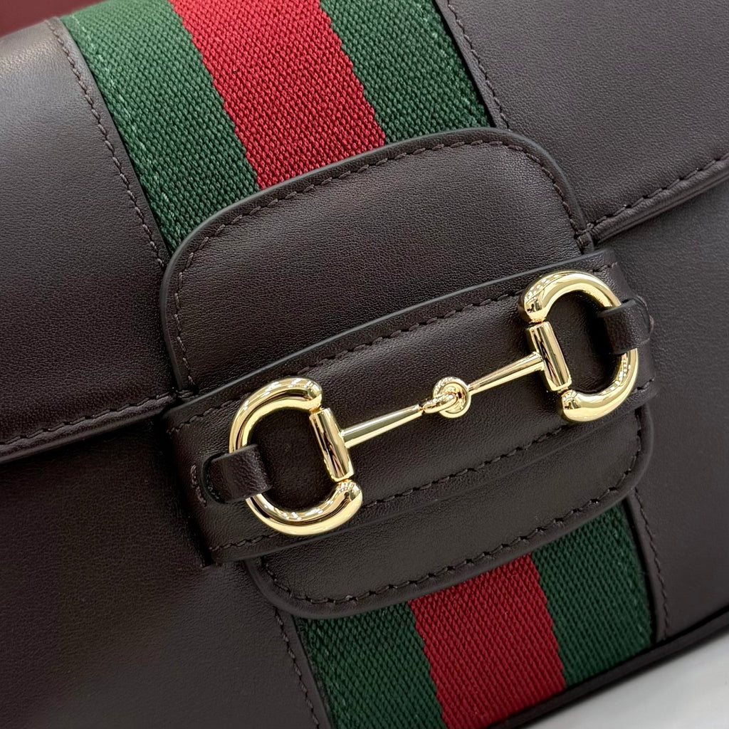 Gucci bag leather flap with gold-tone double buckle and striped webbing strap