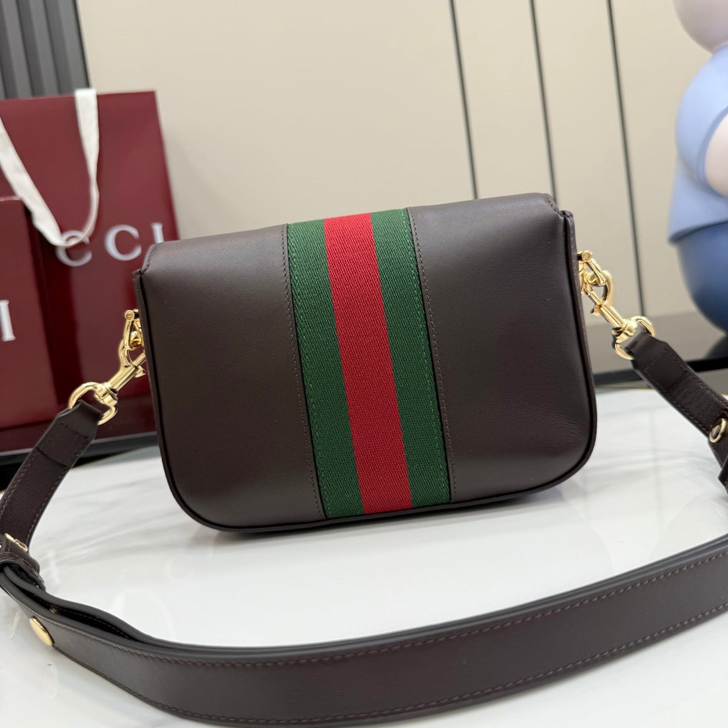 Dark brown leather crossbody bag with Web stripe band and gold tone chain strap