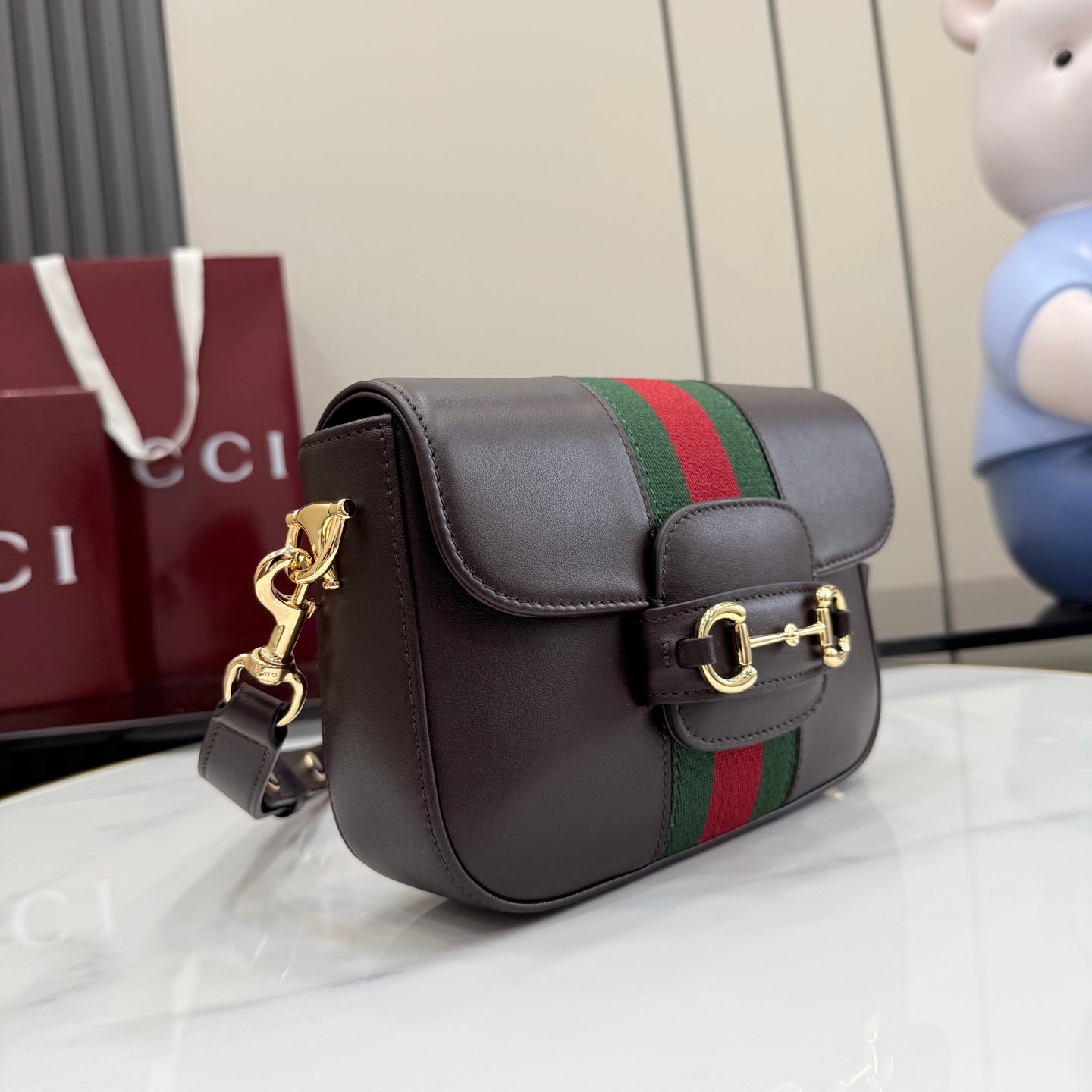 Dark brown leather shoulder bag with flap, green and red stripe, gold chain hardware