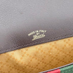 Close-up of Made in Italy Gucci on brown leather above tan lining