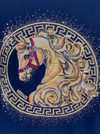 Embroidered circular horse graphic with laurel border on dark fabric