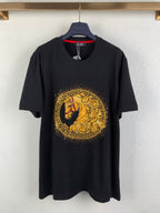 Black graphic T-shirt with gold circular horse emblem on the chest