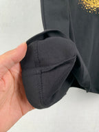 Black T-shirt sleeve cuff with seam stitching close-up