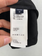 Versace clothing item, black fabric sleeve with care label