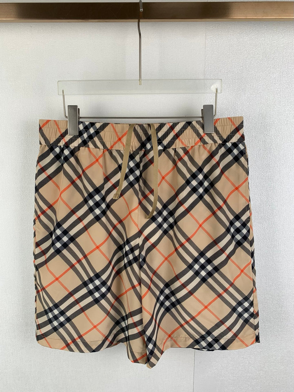 Burberry plaid pants with beige, navy, and red check pattern