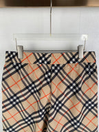 Burberry plaid pants front view with beige navy and red check pattern