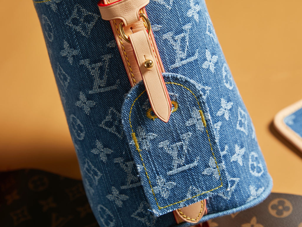 Blue monogram mini bag side tab with gold-toned snap hardware