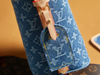 Blue monogram mini bag side tab with gold-toned snap hardware