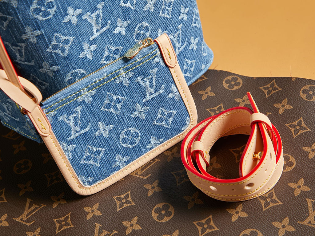 Blue monogram mini bag with white edge piping and red straps