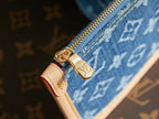 Gold zipper pull on blue monogram mini bag with red pull tab
