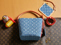 Blue monogram mini bag with red trim and top handle