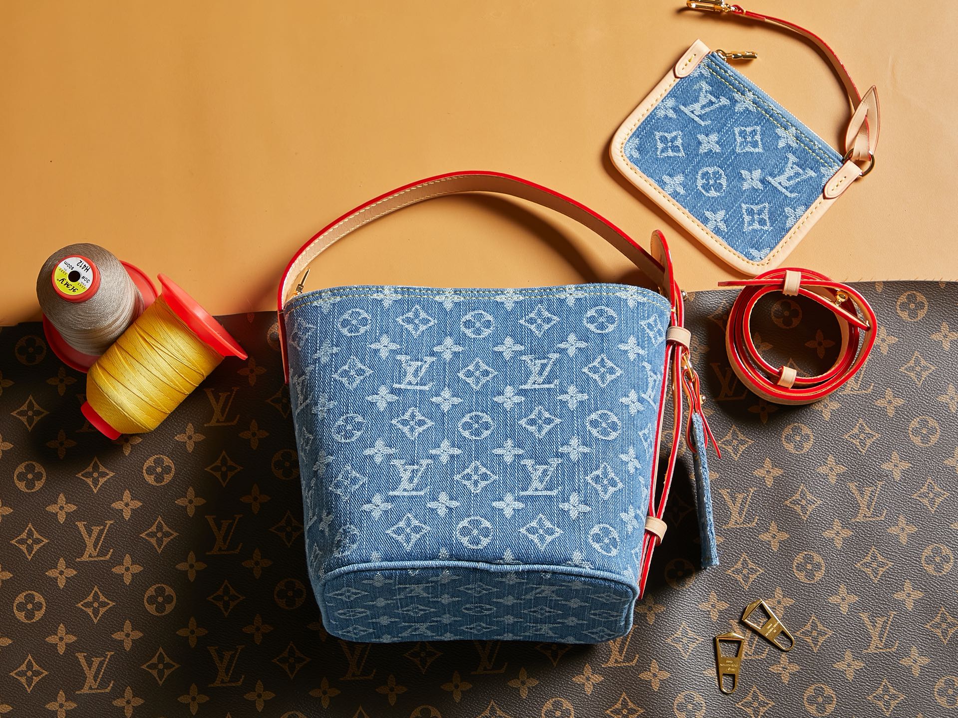 Blue monogram mini bag with red trim and top handle