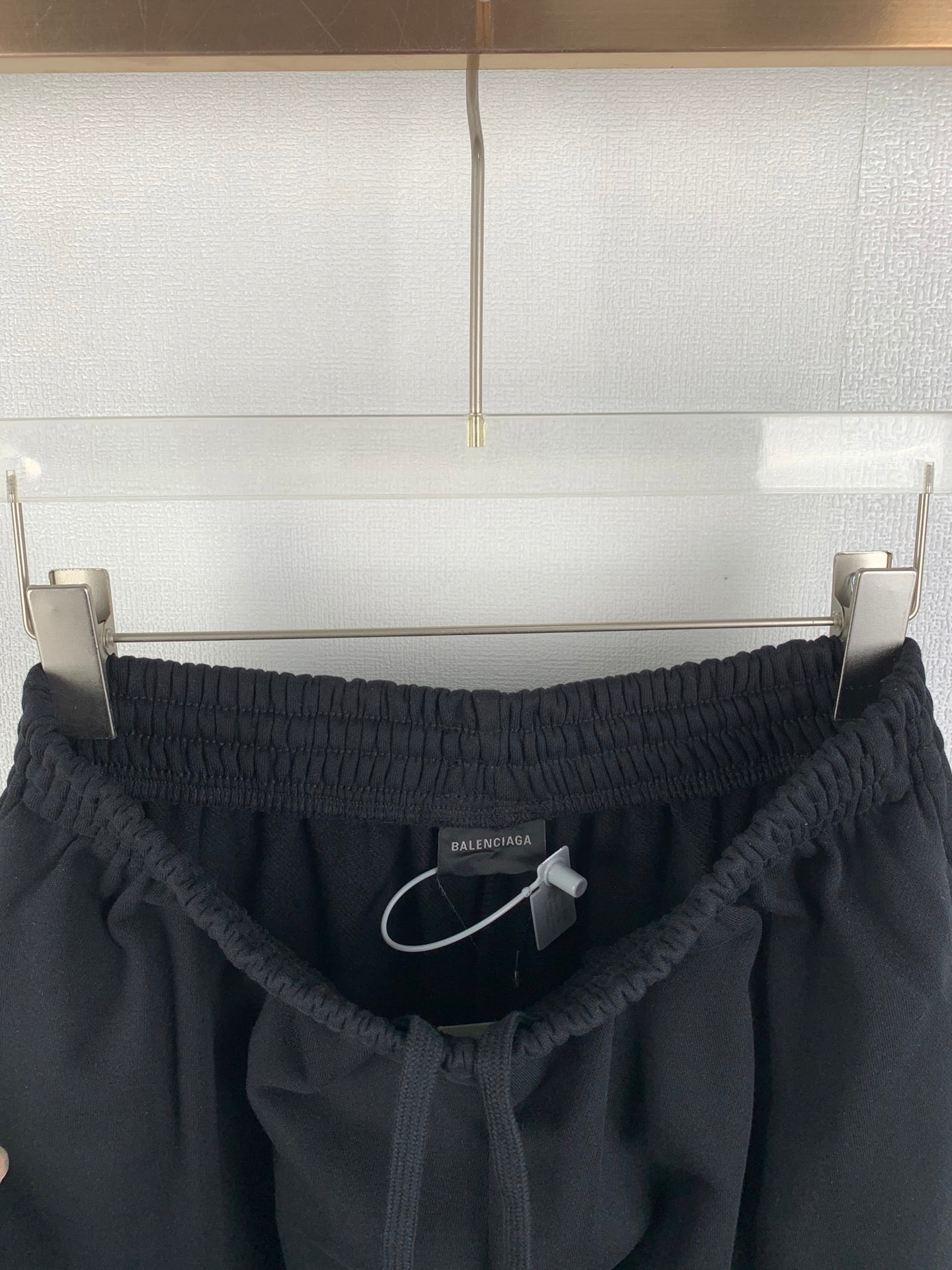 Black Balenciaga pants with elastic waistband and drawstring, front view
