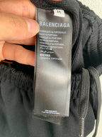 Black pants size M tag with Balenciaga branding and made in Portugal info