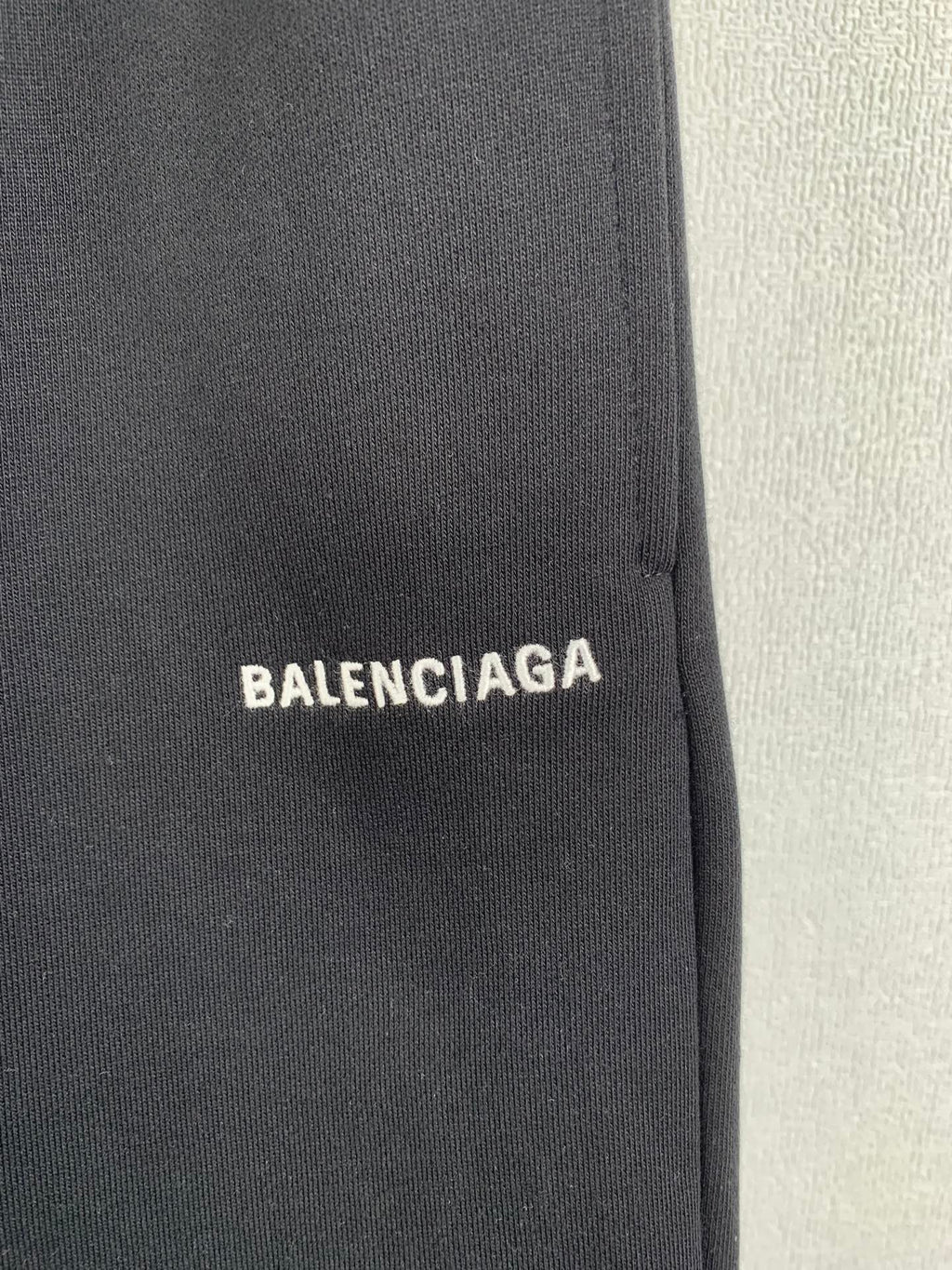 Dark knit fabric panel with BALENCIAGA logo patch