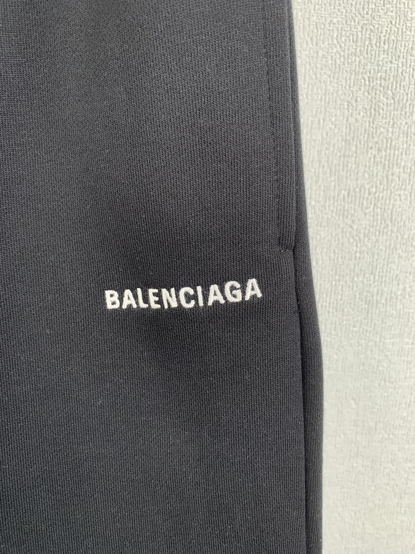 Dark knit fabric panel with BALENCIAGA logo patch
