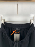 Black Balenciaga pants with elastic waistband and orange drawstring toggle