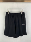 Dark knit shorts with elastic waistband and draped front folds
