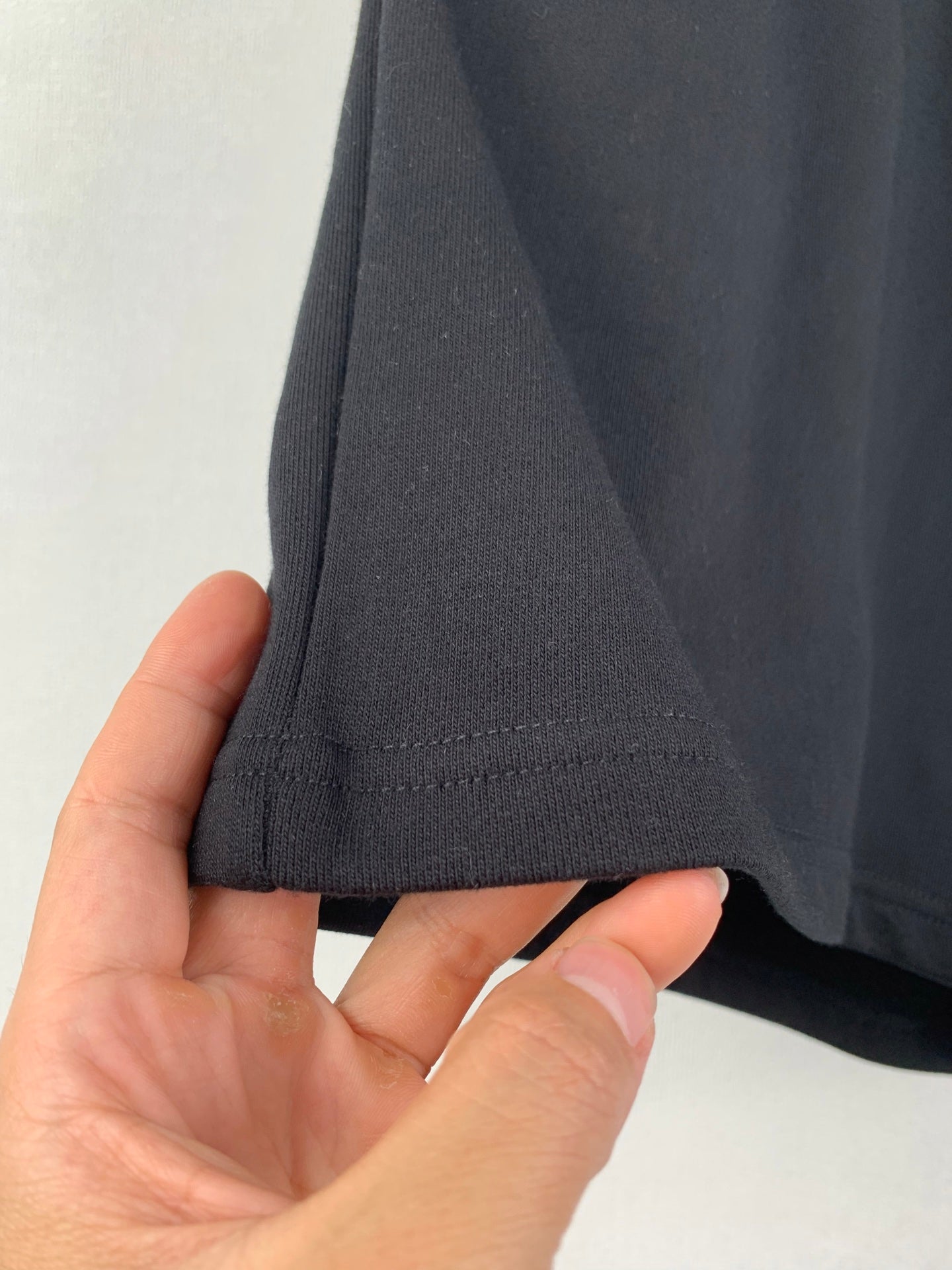 Dark knit shorts hem with stitched cuff and side seam