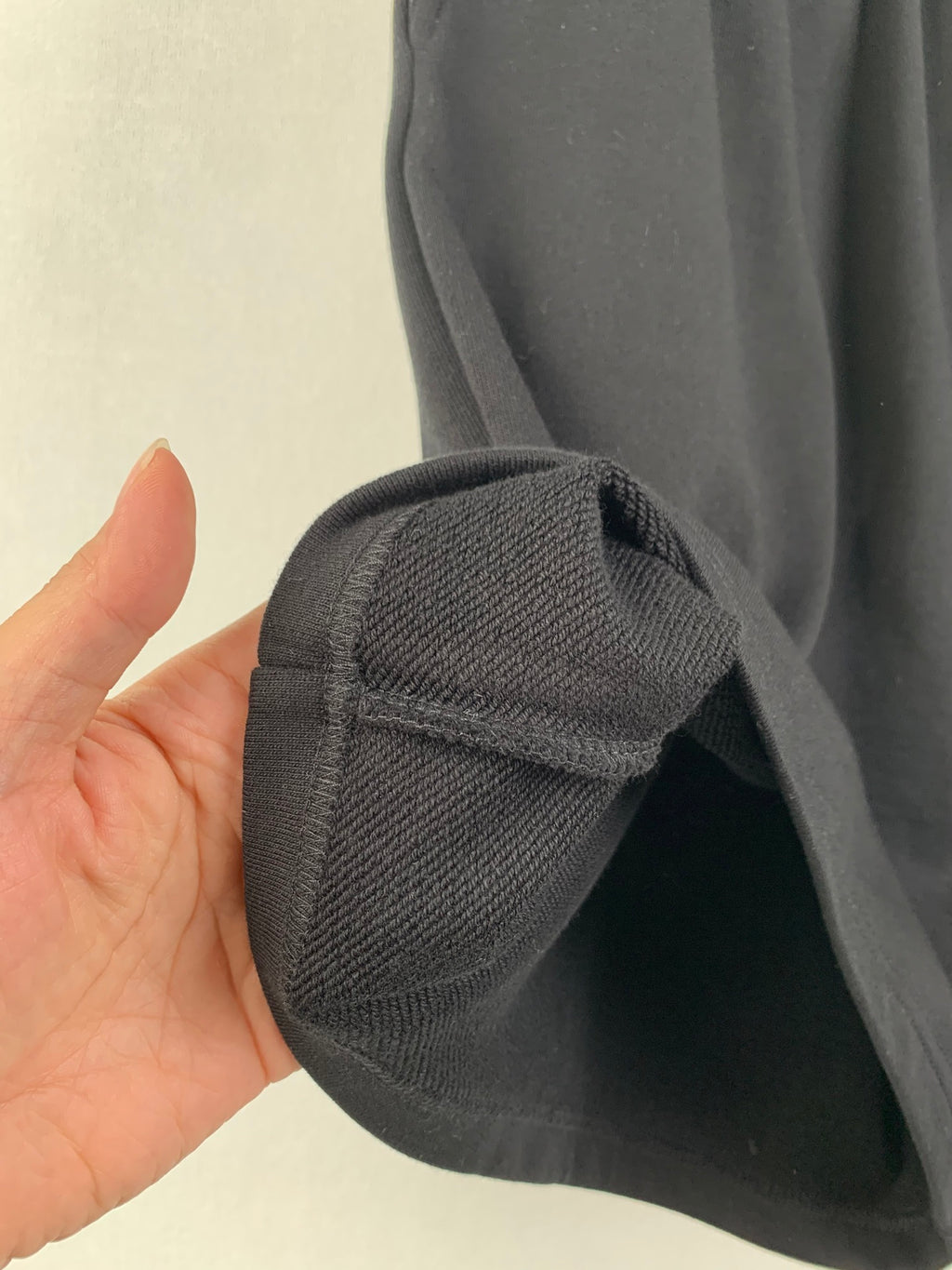 Dark knit shorts cuff with rolled hem and textured fabric weave