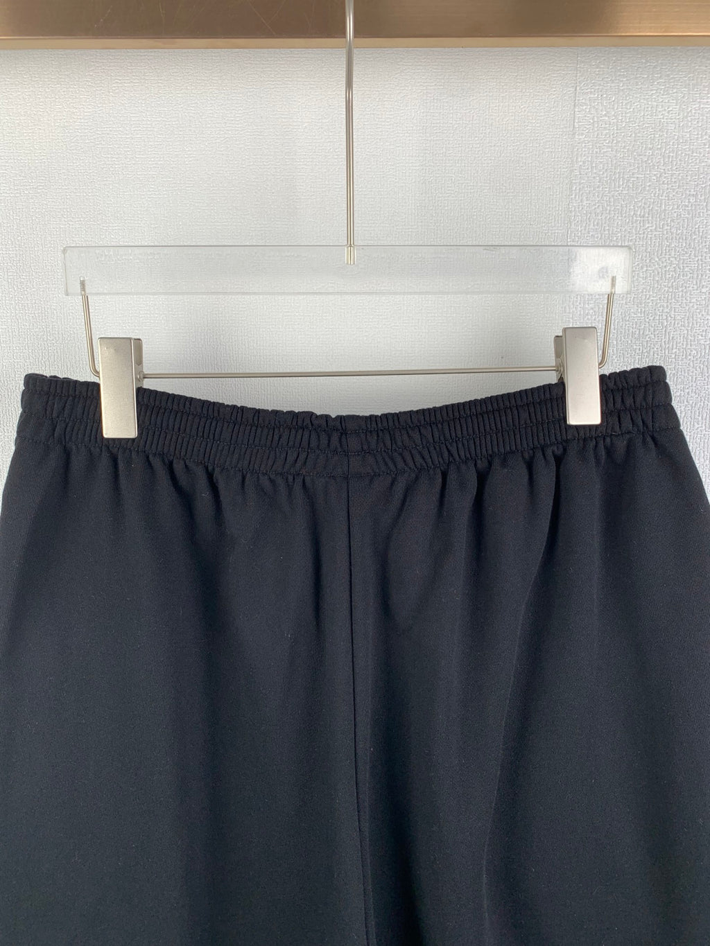 Dark knit shorts waistband view with stitched pleat-like details