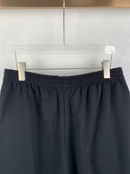 Dark knit shorts waistband view with stitched pleat-like details