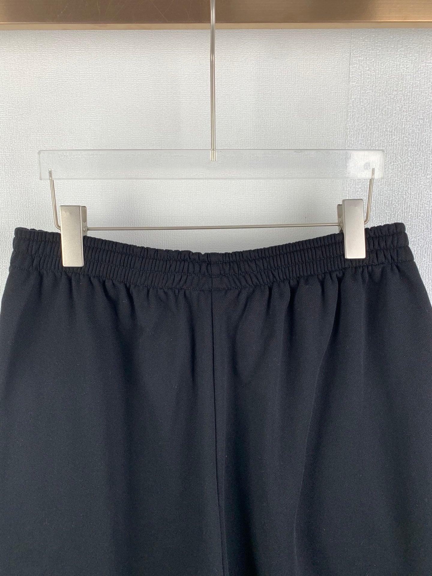 Dark knit shorts waistband view with stitched pleat-like details