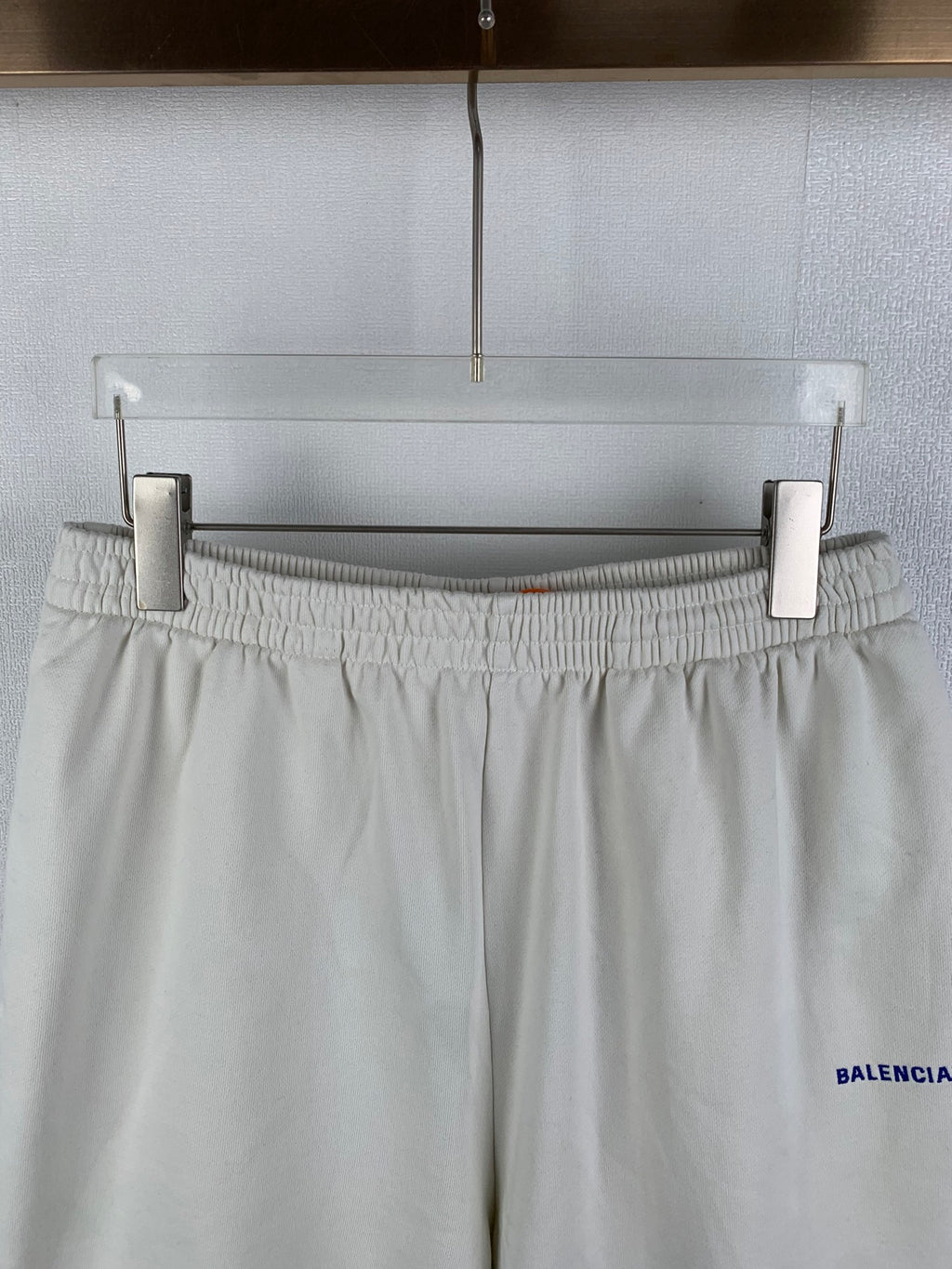 White elastic-waist shorts with gathered waistband and blue BALENCIAGA logo on side