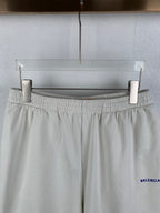 White elastic-waist shorts with gathered waistband and blue BALENCIAGA logo on side