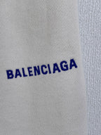 White shorts with close-up view of the blue BALENCIAGA logo
