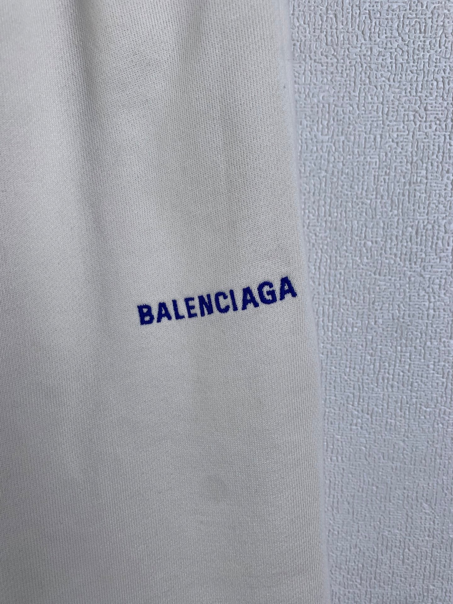 White fabric with blue BALENCIAGA wordmark print