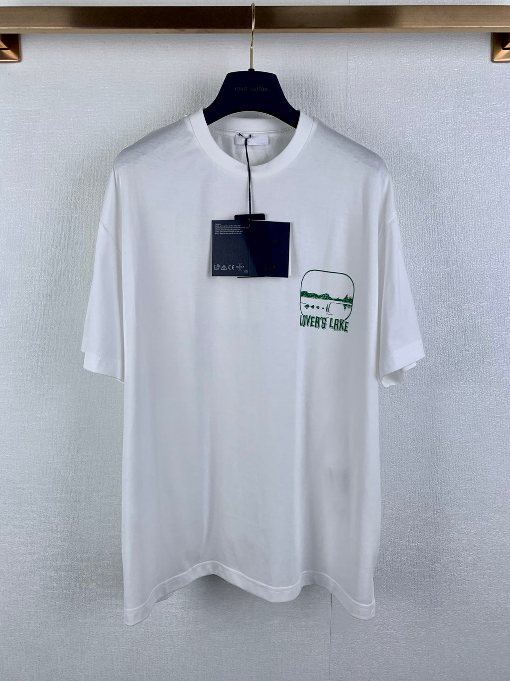 White crewneck T-shirt with green "LOVER'S LAKE" graphic print on chest